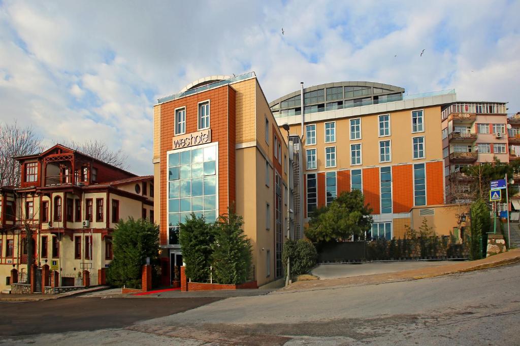 a building with a sign on the front of it at Wes Hotel in Kocaeli