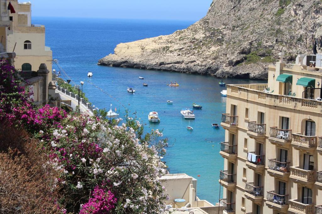 a view of a bay with boats in the water at Serenity - Bellevue Gozo in Xlendi