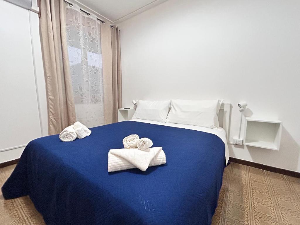 a hotel room with a bed with towels on it at Villa Aria di Mare in Carini