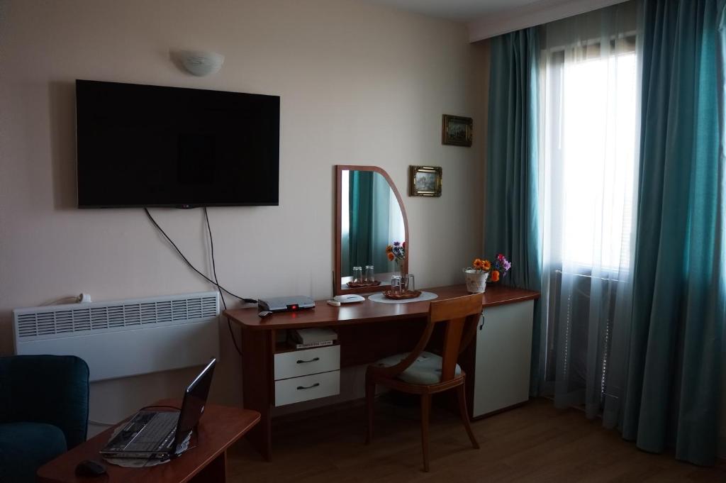 a room with a desk with a computer and a window at Guest House Golden Flake 4km from Bolata beach in Bŭlgarevo