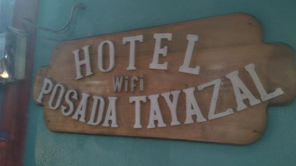 a sign that says hotel with pueblo taza at Hotel Posada Tayazal in Flores