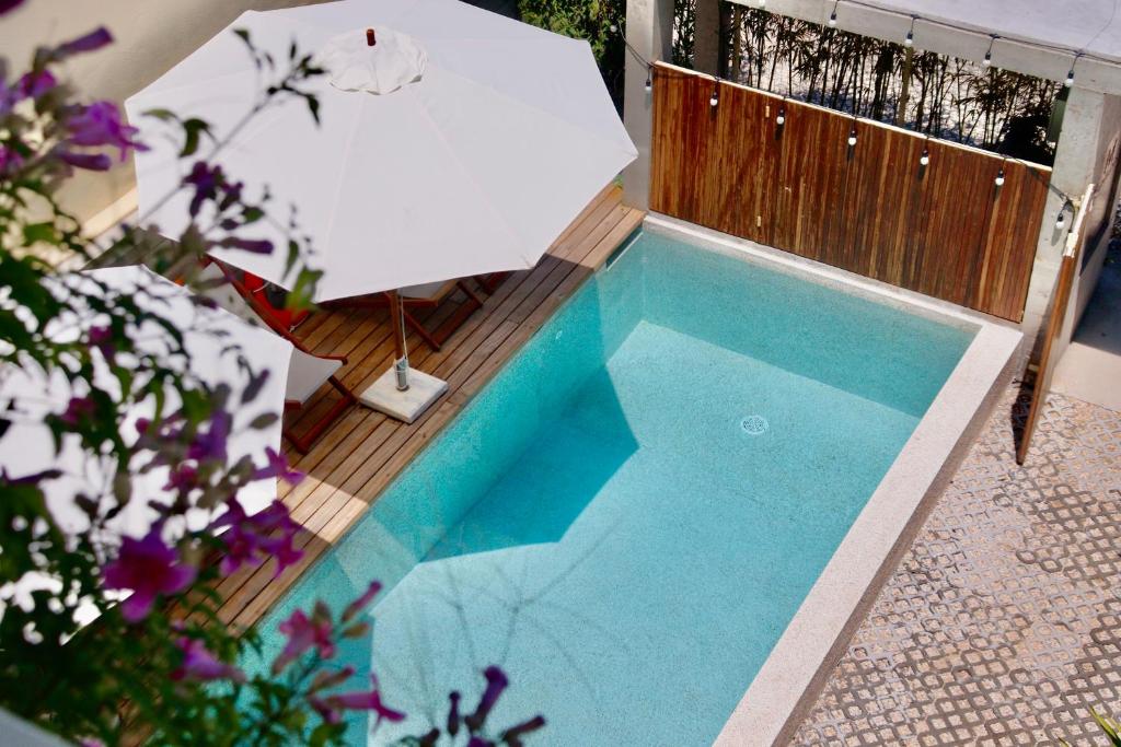 an overhead view of a swimming pool with an umbrella at Marvelous Homestay Hoi An in Dien Ban