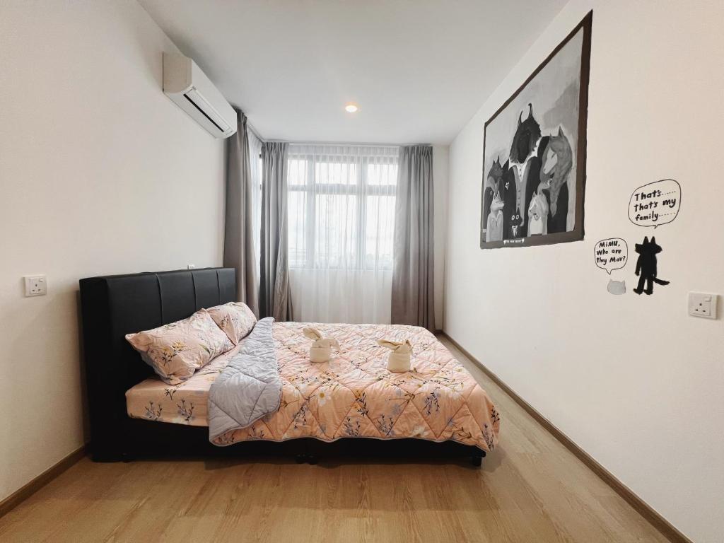 a bedroom with a bed in the corner of a room at Your Comfy Samarahan Retreat in Kuching