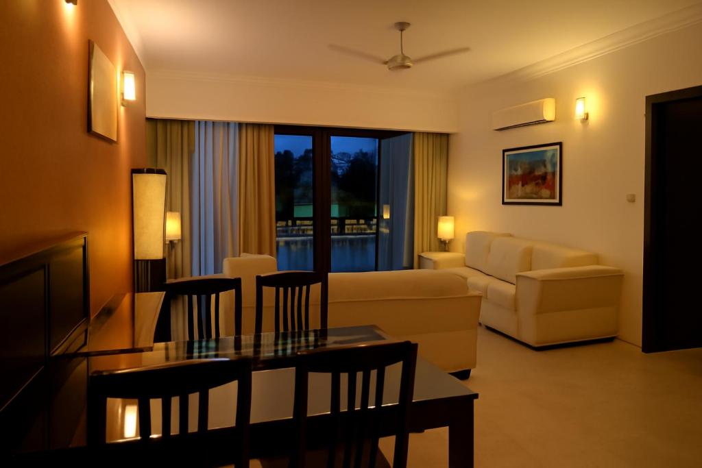a living room with a couch and a table at Riviera Hermitage Luxury Apartment in Anjuna