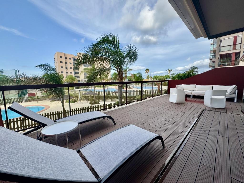 a balcony with furniture and a view of a pool at Lucerna II, Bajo 2 in Dehesa de Campoamor