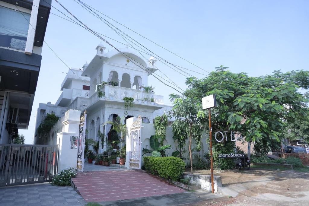 a white building with a sign in front of it at Otla - A Heritage Boutique Hotel, Jaipur in Jaipur