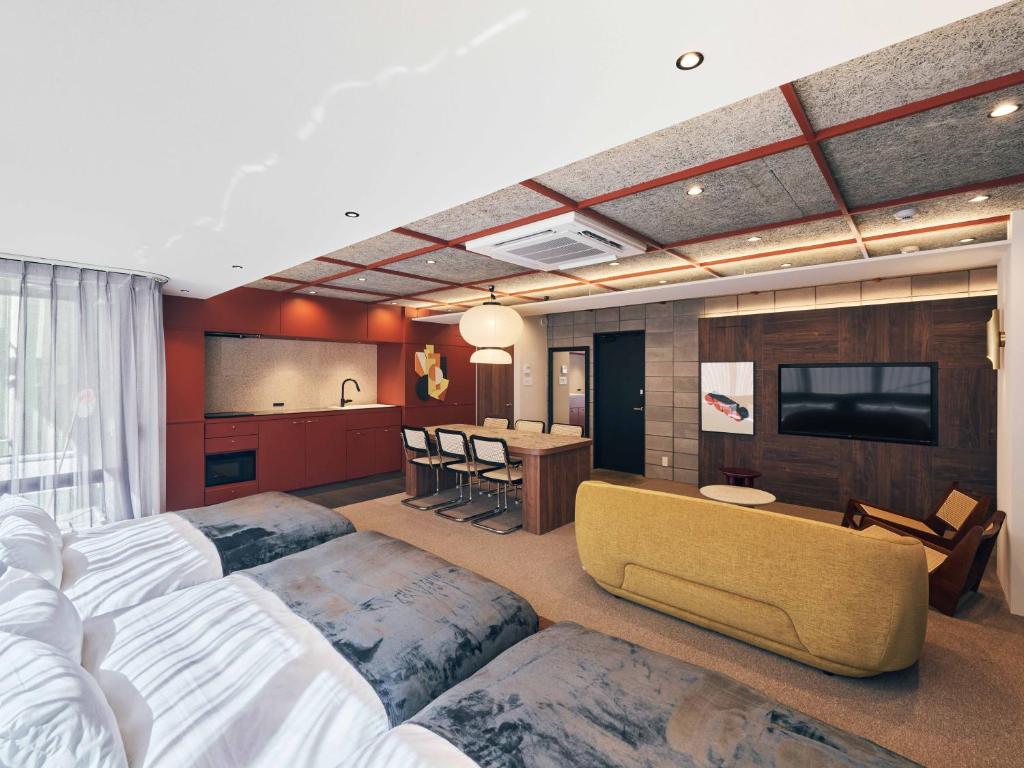 a hotel room with two beds and a television at illi Jam Shinsaibashi in Osaka