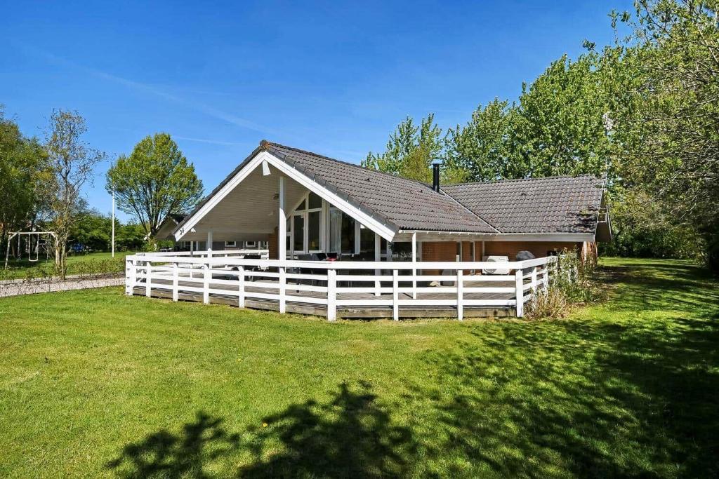 a house with a white fence in front of it at C11711-Hemmet-Strandvaenget-39 in Falen