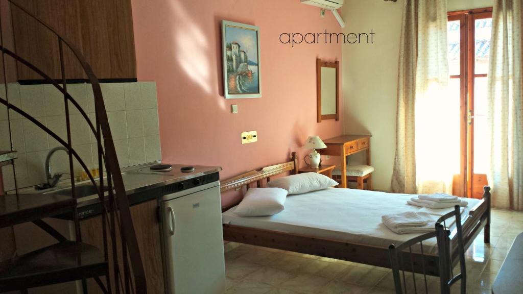 a small bedroom with a bed and a sink at Kristi in Póros Kefalonias