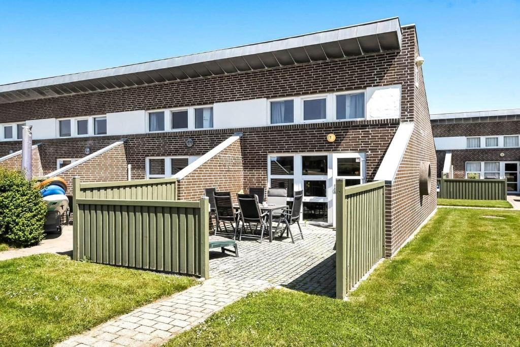 a brick house with a patio with chairs in the yard at C11729-Hemmet-Vester-Faelled-192-I1 in Falen