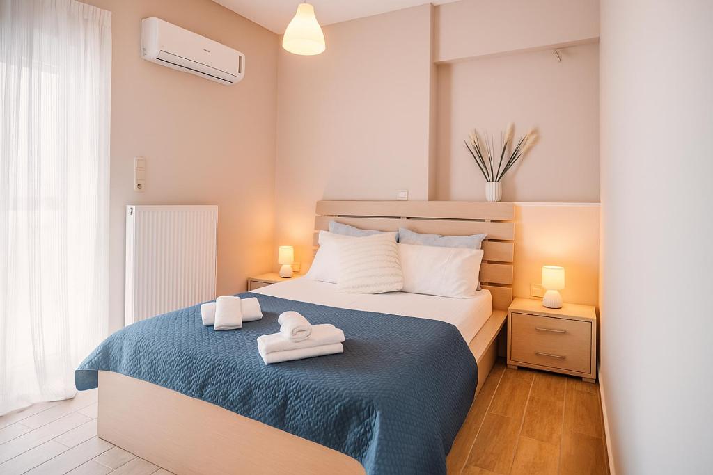a bedroom with two towels on a bed at Onda Blu Deluxe Loutraki in Loutraki