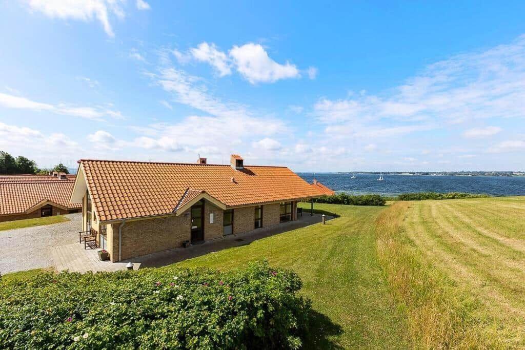 a house with a large yard and a field at SB125-Egernsund-Marinavej-28 in Rendbjerg