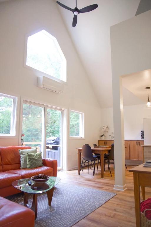 a living room with a couch and a table at Lincolnville 2BR - Beach Vibes & Backyard BBQ in Lincolnville