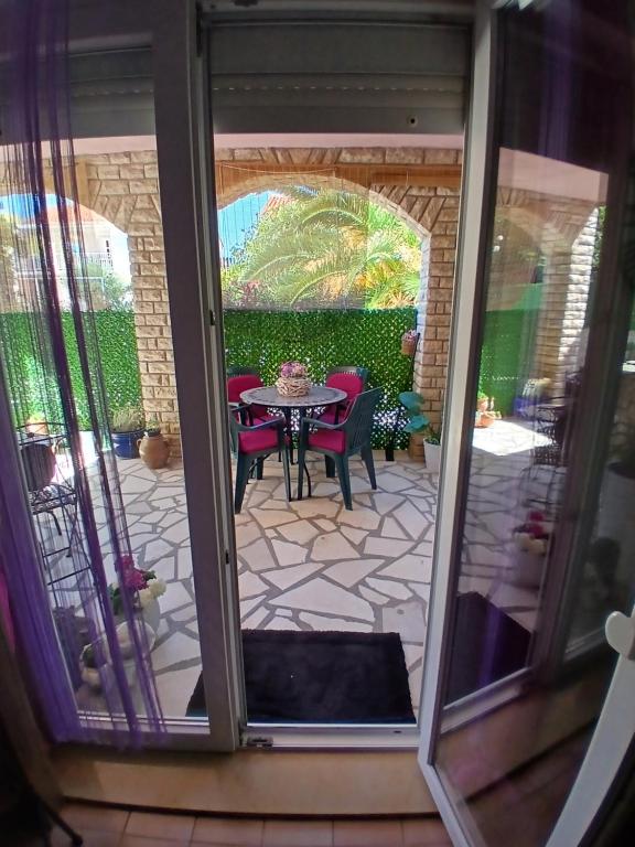 a view of a patio with a table and chairs at DosPalmeras in Vir