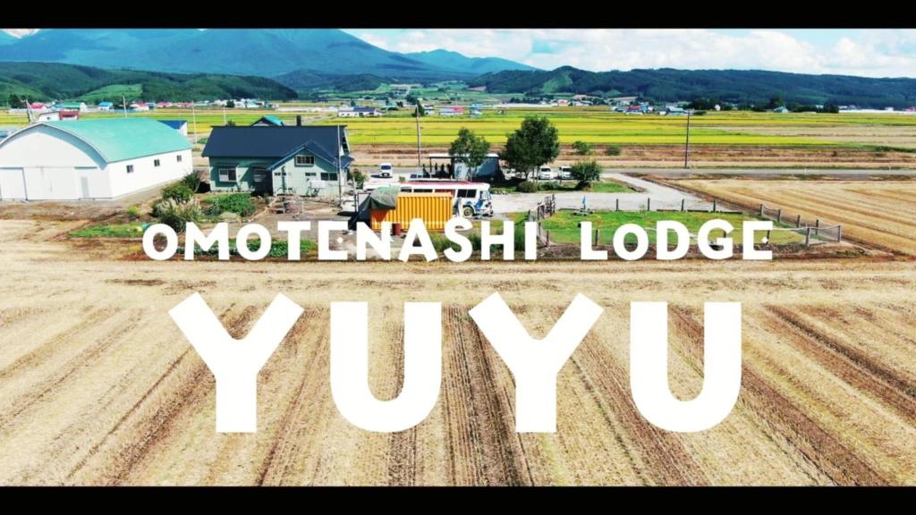 an aerial view of a farm with the words urbanwealth lodge ywx at OMOTENASHI LODGE Yuyu - Vacation STAY 11761 in Nakafurano