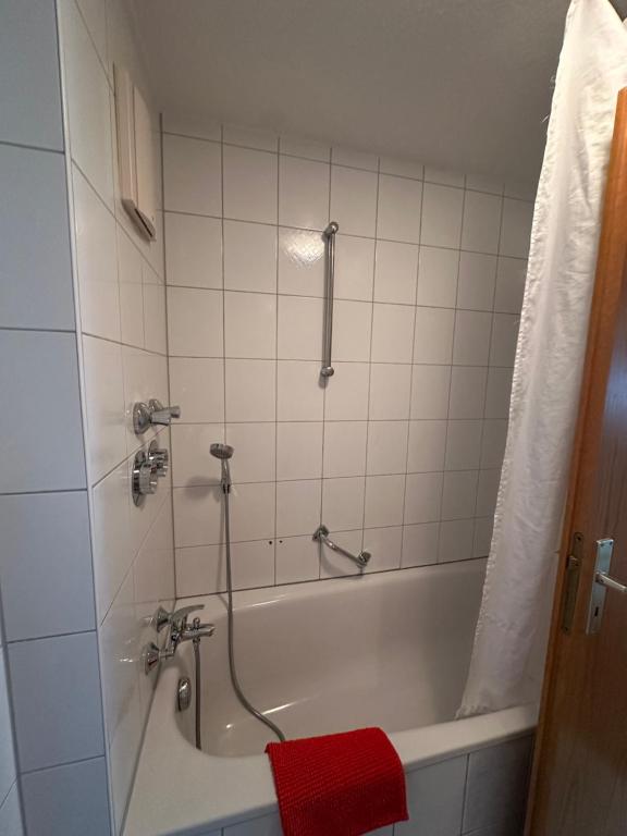 a bathroom with a bath tub with a red towel at Apartment FIVE - EP Ticket Garantie in Rust