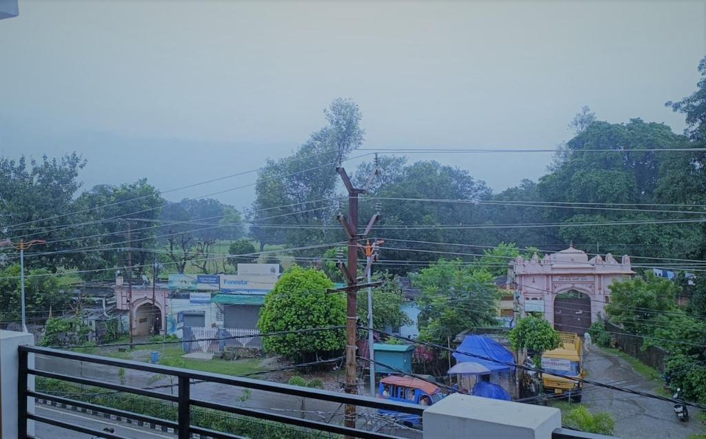 a view of a town with buildings and power lines at Prem Home Stay in Rishīkesh
