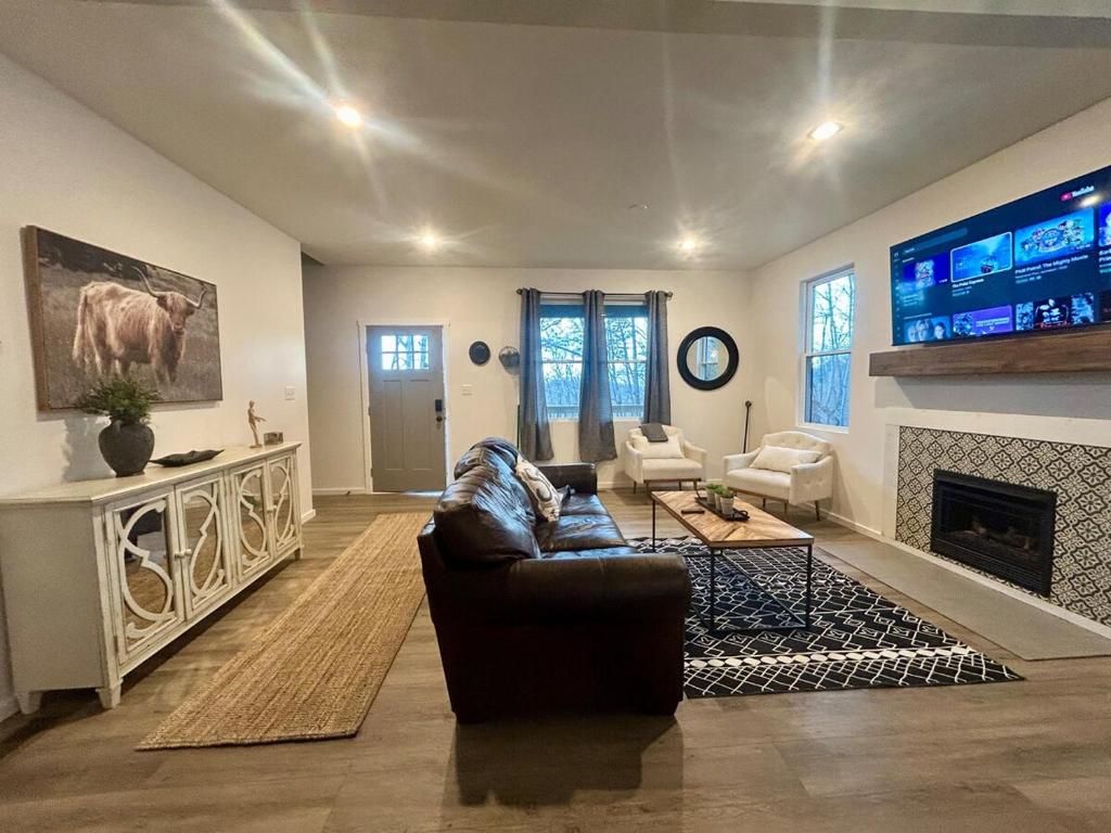 a living room with a couch and a fireplace at New Home! Hilltop Hideaway near Historic Dahlonega in Dahlonega