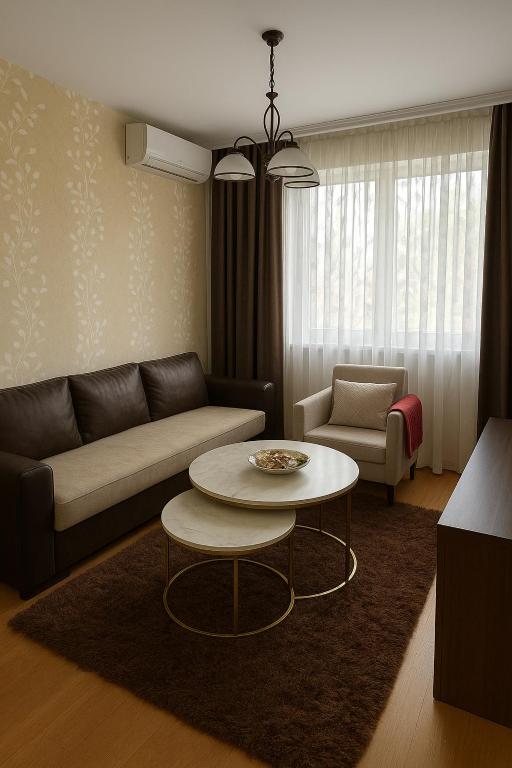 a living room with a couch and a table at Apartman Bloom in Sarajevo