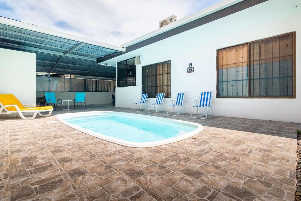 a large pool in a room with chairs and a table at Fun! Great Location-near Beaches-shopping-medical in Parrita