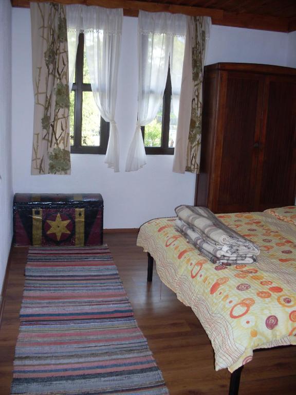 Postel nebo postele na pokoji v ubytování Tsutsovi House