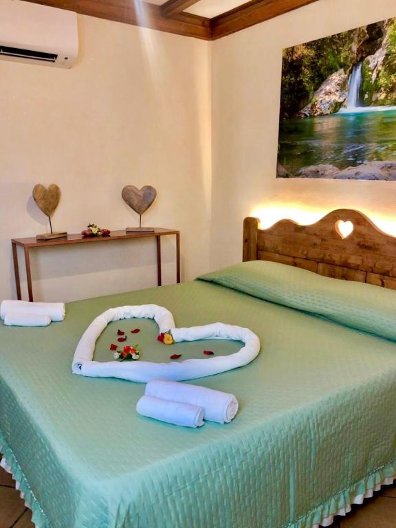 a bedroom with two beds with a heart shaped bed at Il Borgo Guest House Subiaco in Subiaco