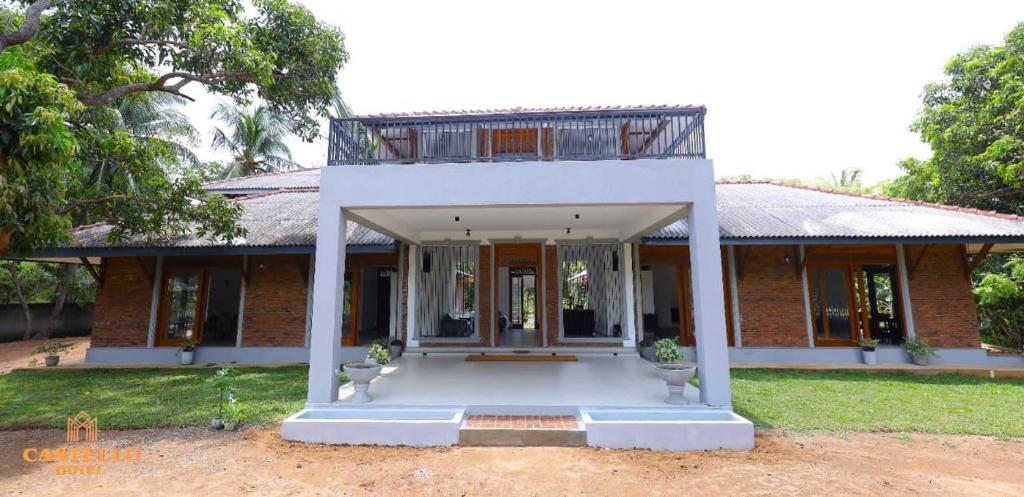 a brick house with a balcony on top of it at Castello Hotel in Polonnaruwa