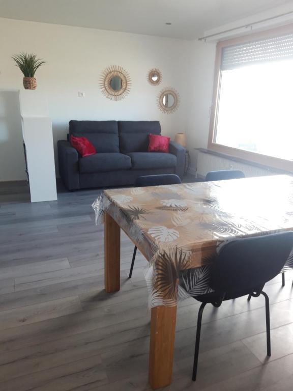 a living room with a table and a couch at Gambetta Insolite in Chambéry