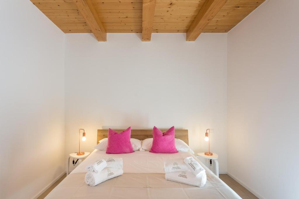 Ένα ή περισσότερα κρεβάτια σε δωμάτιο στο Dimora Caprera - Appartamenti