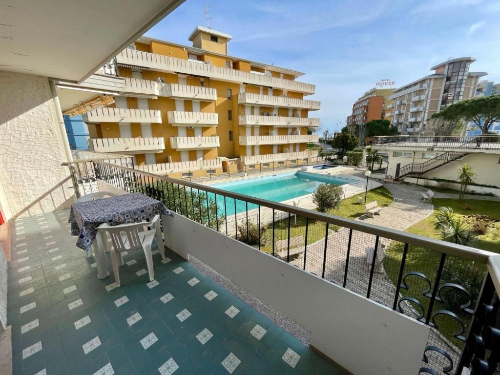 a balcony of a hotel with a swimming pool at Flat with shared pool-Beahost in Porto Santa Margherita di Caorle