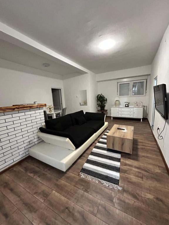una sala de estar con un sofá y una mesa en Apartman FIKA, en Prijepolje