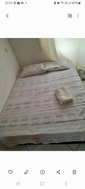a bed with a blanket on top of it at Casa Bela Vista in Blumenau