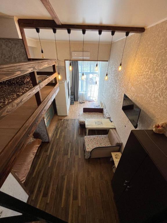 a room with several couches and a staircase in a building at Студия лофт in Chornomorsk