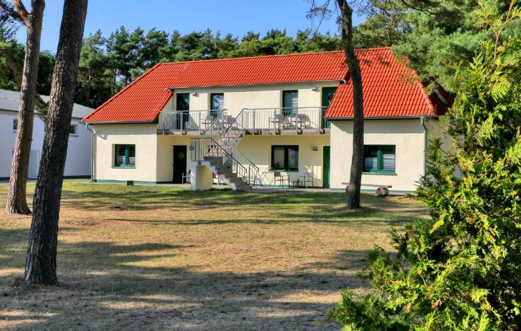 a house with an orange roof and a staircase at Beach Front Apartment In Altenkirchen With Wifi in Altenkirchen