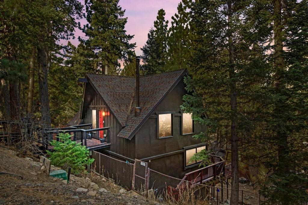 a wooden house in the woods with trees at TreeLicious Jacuzzi Cozy Chalet close to Slopes in Big Bear Lake
