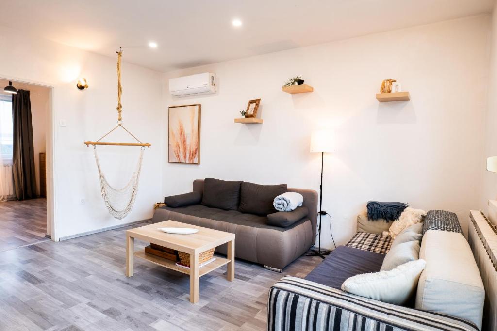a living room with a couch and a table at The Loft in Koper