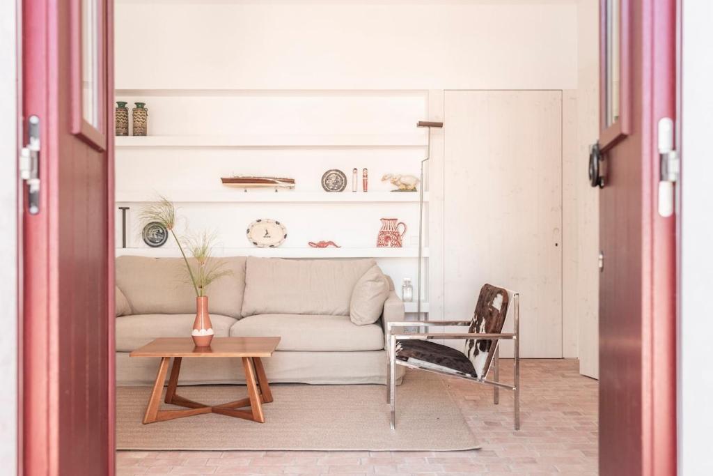 a living room with a couch and a table at Dona Ana House in Tavira