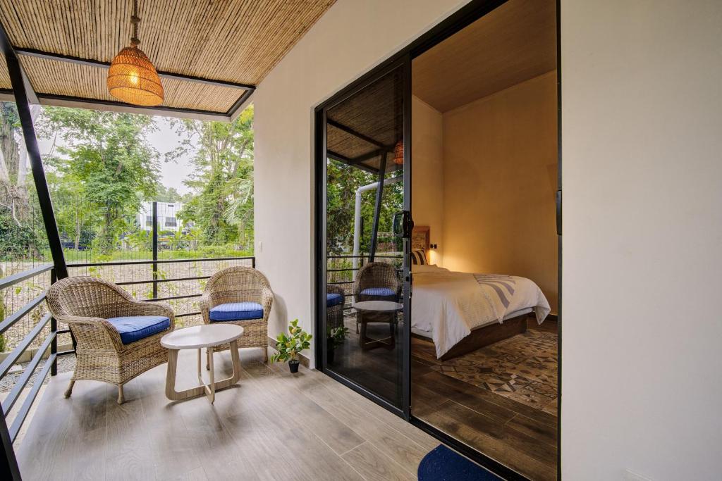 a bedroom with a bed and a balcony at Casa AMALFI Pool House Playa Neg in Puerto Viejo