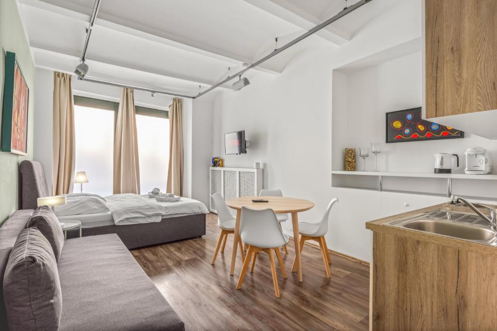 a room with a bed and a table and chairs at Beautiful Apartment city center in Vienna