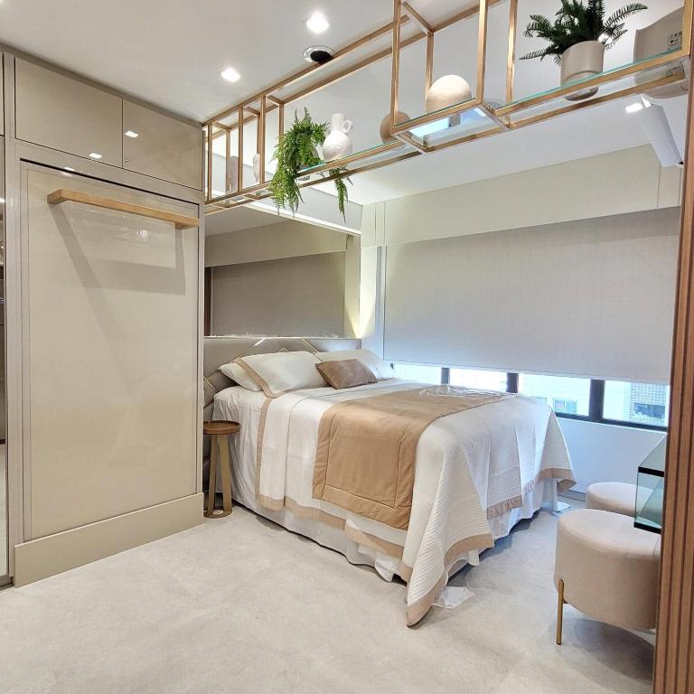 a bedroom with a bed in a room with shelves at FLAT LUXO em BOA VIAGEM Prox PRAIA, SHOPPING e AEROPORTO in Recife