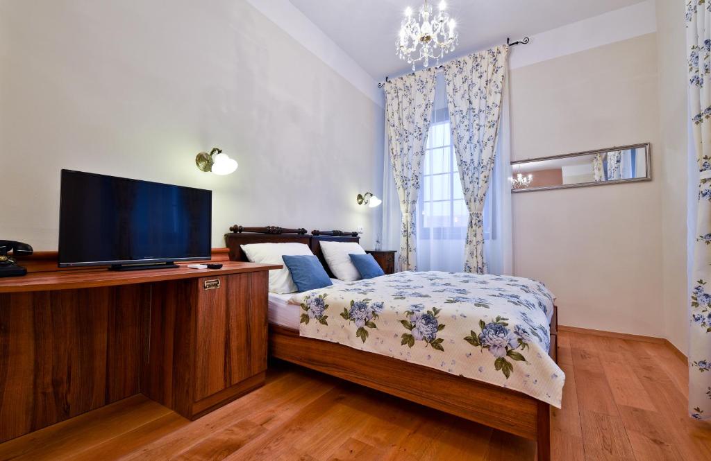 a bedroom with a bed and a flat screen tv at Guesthouse Bistra in Vrhnika