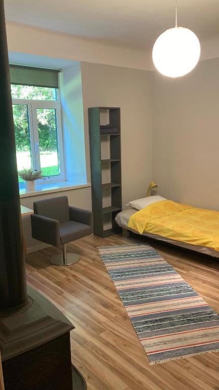 a bedroom with a bed and a desk and a chair at Āgenskalns 2 in Riga