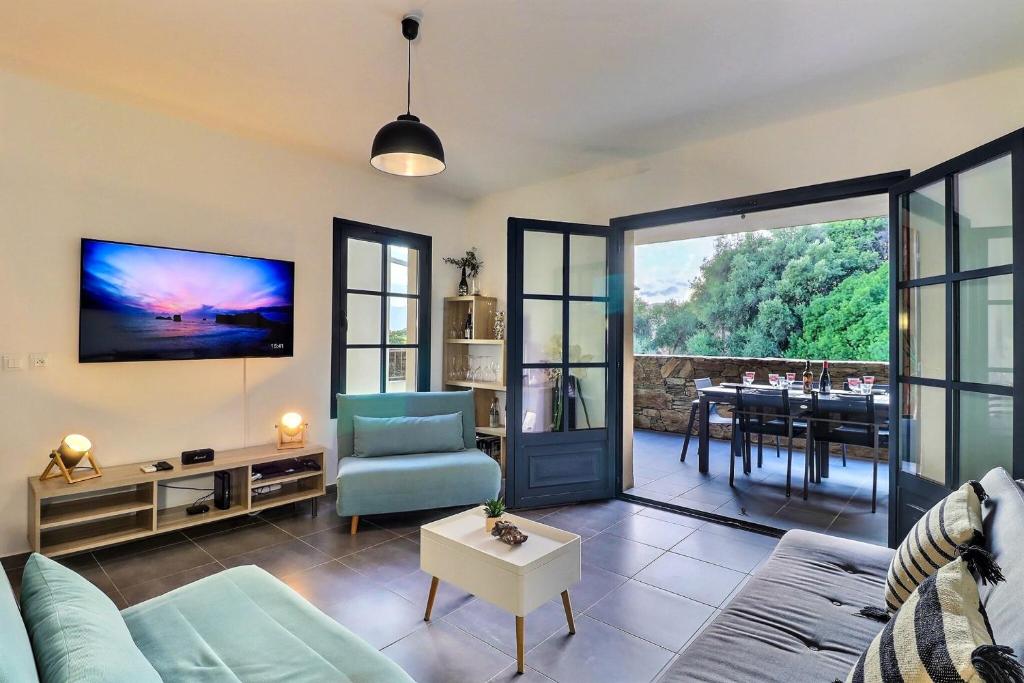 a living room with a couch and a table at Rocca Bella Escape by the Sea and Vineyards in Patrimonio