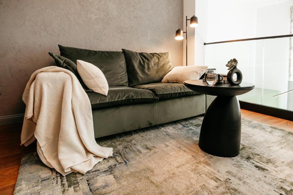 a living room with a couch and a table at Matcha Studio in Bucharest