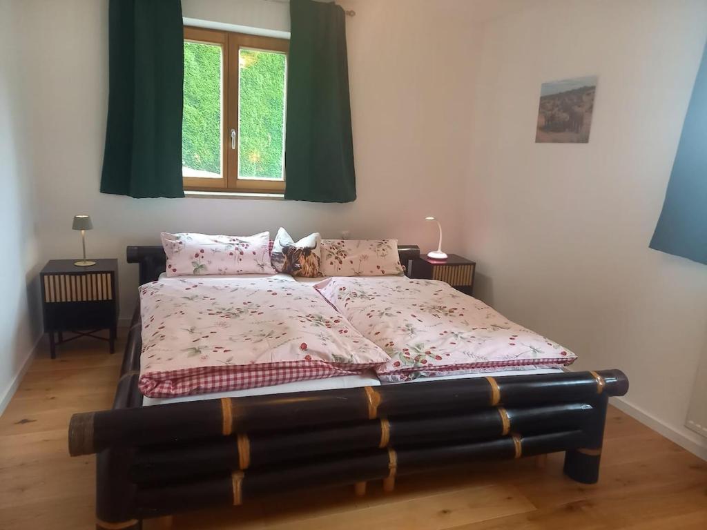 a bedroom with a bed with a bedspread and a window at Idyllic apartment in Bavaria, near Munich, Freising, Erding 