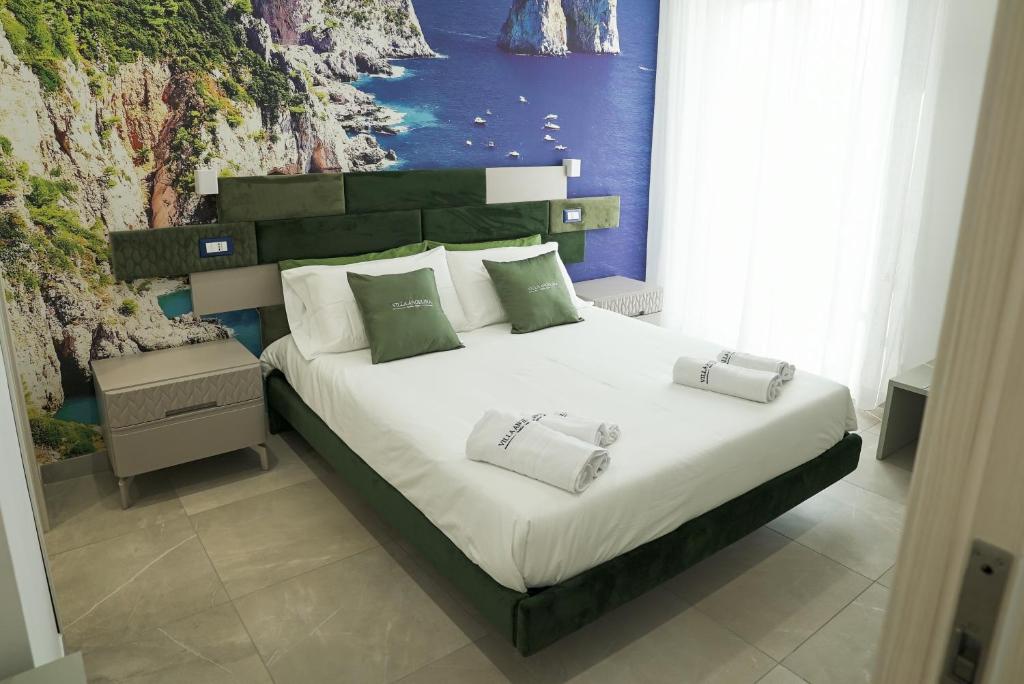 a bed with two pillows on it in a bedroom at Villa Angelina in Pompei