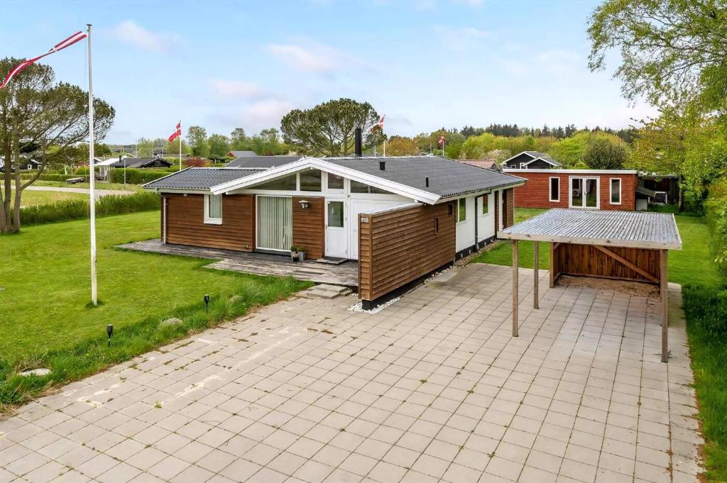 a house with a large patio in front of it at Family-Friendly Activity House By The Sea in Frederikshavn