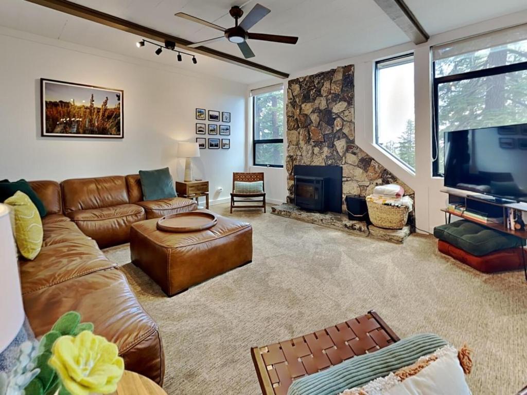 a living room with a leather couch and a flat screen tv at 1849 Condos 542 condo in Mammoth Lakes