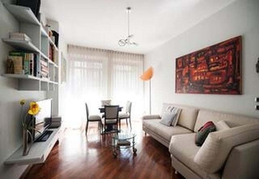 a living room with a couch and a table at "Suite Sempione Park" 2 bedrooms - 2 bathrooms in Milan