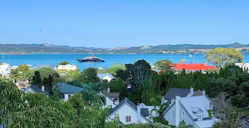 a boat in the water next to a town with houses at Forty9 Steps in Russell
